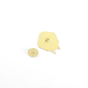 Detail of gold metal pin back with butterfly clutch fastener for gym badge accessory