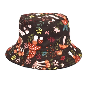 Detailed view of colorful mushroom and floral patterns on dark fabric bucket hat