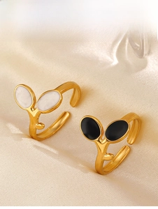 Detail of adjustable 18K gold plated leaf rings with black and white enamel finishes