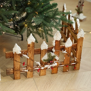 Rustic wooden Christmas fence with artificial snow and red berries on a cozy wood floor