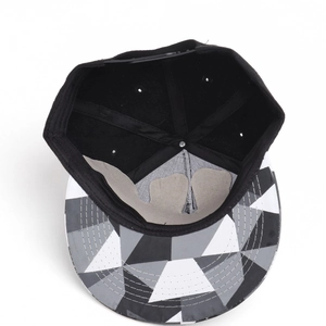 Detail of hip hop hat featuring geometric patchwork brim and adjustable snapback strap