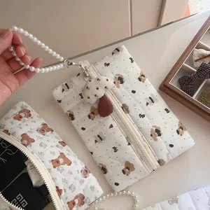 Detail of quilted bear handbag with pearl handle, plush mushroom charm and inner lining