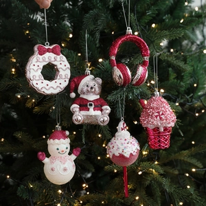 Pink and red Christmas ornaments set including bear and sweets on festive tree