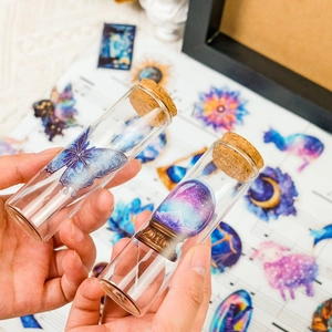 Detail showing waterproof blue butterfly and crystal ball stickers on glass bottles