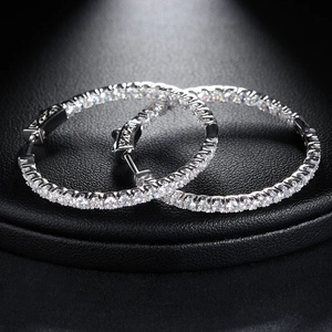 Macro detail of silver-colored brass hoop earrings with micro-pave 4A cubic zirconia