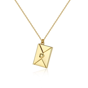 Close-up of golden envelope pendant with heart motif and polished mirror finish surface