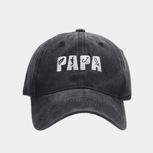 Close-up of PAPA embroidery with fishing motifs on washed black vintage baseball cap