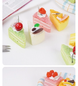 Detailed close-up of colorful triangle mousse cake squishies with cream and fruit decor