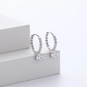 Detailed macro shot of S925 sterling silver hoop earrings with white cubic zirconia stones