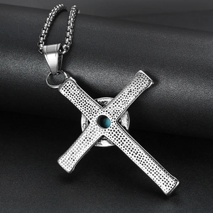 Vintage silver cross pendant with turquoise inlay and box chain on black background