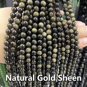 Macro detail of natural golden sheen obsidian beads string for jewelry making