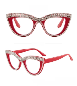 Detail view of red cat-eye reading glasses with hand-set rhinestones and luxury finish