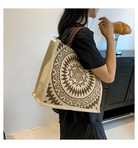 Linen tote bag detail showing large capacity and beige-brown geometric patterns