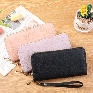 Long leather zip-around wallet with floral embossing and wristlet strap in three colors
