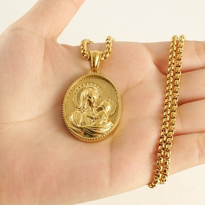 Detailed close-up of 18k gold-plated Virgin Mary oval pendant on a box chain