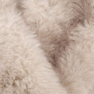 Close-up of fluffy beige faux fur collar showing soft texture and premium plush material