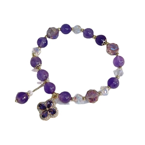 Natural amethyst flower bracelet with zircon clover pendant on a clean white background