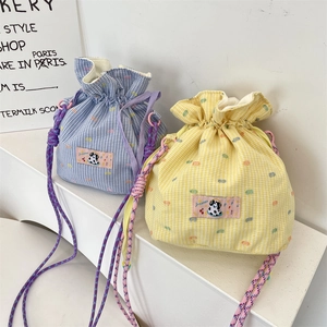 Drawstring bucket bags with colorful plaid patterns and woven shoulder straps