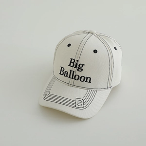 Close-up of Big Balloon embroidery and contrast stitching on beige cotton baseball cap