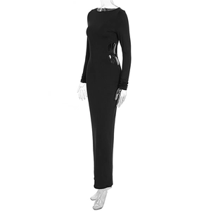 Detailed close-up of side cut-out with metal buckle on black long sleeve maxi dress