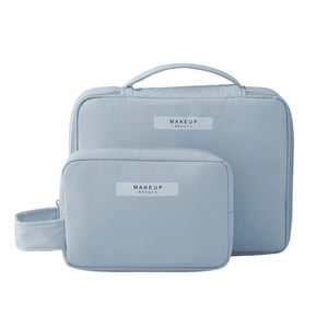 Set of two blue waterproof makeup bags with handle and 'MAKEUP BEAUTY' label on white background