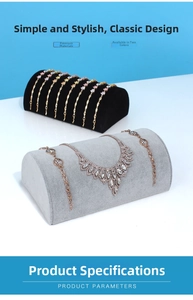 Detail view of gold necklaces and bracelets on velvet semi-circular jewelry display stands