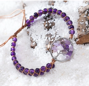 Close-up of adjustable woven tree of life bracelet with purple amethyst beads and stones