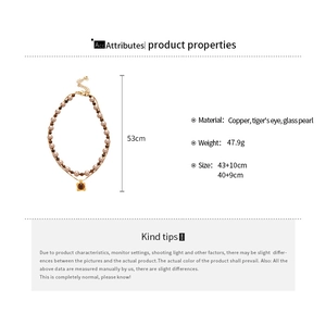Detailed view of tiger's eye pendant and layered glass pearl necklace dimensions