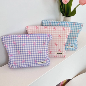 Three cotton makeup bags featuring floral bow patterns in purple, pink and blue plaid