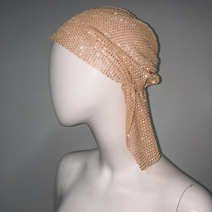 Detail of champagne gold fishnet durag with sparkling rhinestones and long tail