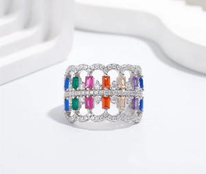 Macro shot of 925 silver wide ring with rainbow gemstones and hollow wave edges