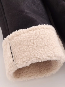 Detail of faux leather pilot jacket cuff with thick cream faux shearling lining
