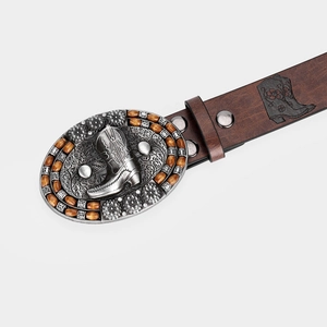 Macro detail of vintage brown leather belt with carved cowboy boot and silver floral buckle