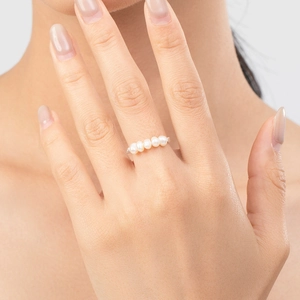 S925 sterling silver ring featuring five white pearls worn on finger in a close-up view