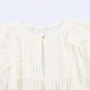 Women's cream ruffled chiffon blouse featuring delicate lace trim and gold button detail
