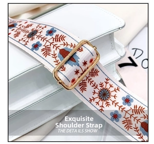 Close-up of white leather square bag featuring a wide floral jacquard woven strap