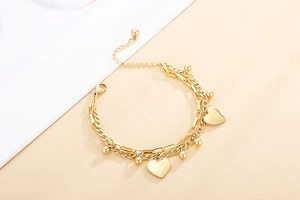 Detail view of gold-layered heart pendant bracelet with adjustable extension chain