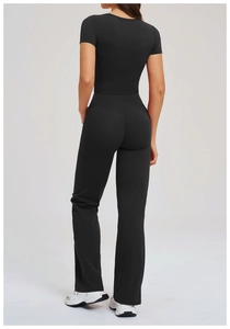 Back view of black slim-fit yoga set with short-sleeve top and flared leggings