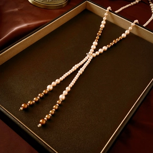 Detail of layered pearl necklace with champagne crystals and cream pearls in jewelry tray