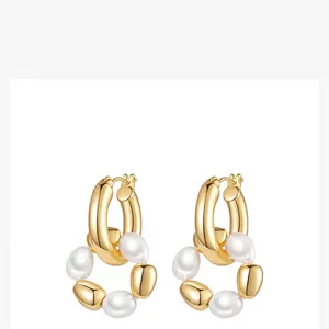 French baroque style earrings with gold hoops and irregular white pearls on a white background