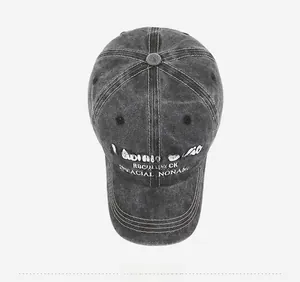 Top view of dark grey washed denim baseball cap with white 3D embroidery detail