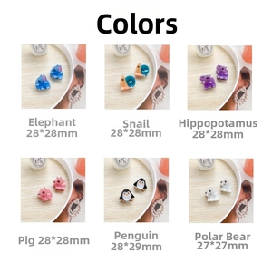 Detail view of 6 cartoon animal hair clips with dimensions on wood background
