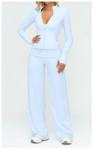 Detail of light blue yoga set featuring thumbhole cuffs and high-waisted wide-leg pants