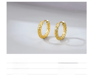 Macro shot of minimalist gold textured earrings in vacuum plated titanium steel