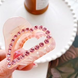 Pink heart-shaped hair claw clip with rhinestones for elegant women's hairstyles
