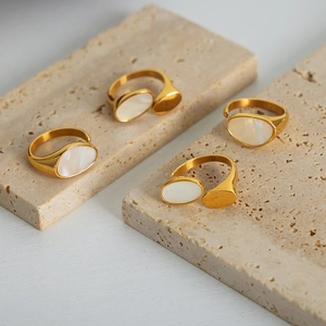Set of four gold-plated stainless steel open rings with elegant white mother of pearl inlays