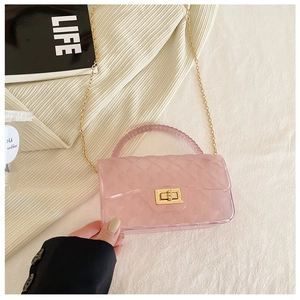 Detailed view of pink jelly bag with pearl handle, metal chain and gold clasp
