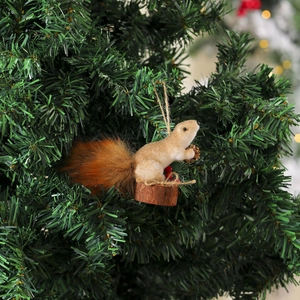 Close-up of realistic squirrel Christmas tree ornament with faux fur and pine cone details