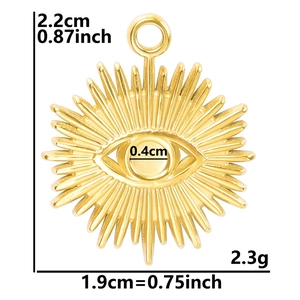 Macro detail of golden sunburst pendant showing precise dimensions and polished finish