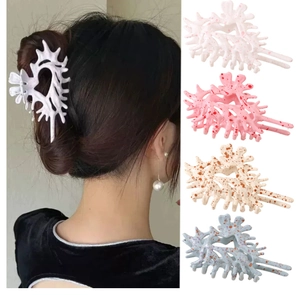 Detail showing colorful conch-shaped claw clips in four patterns for hair styling